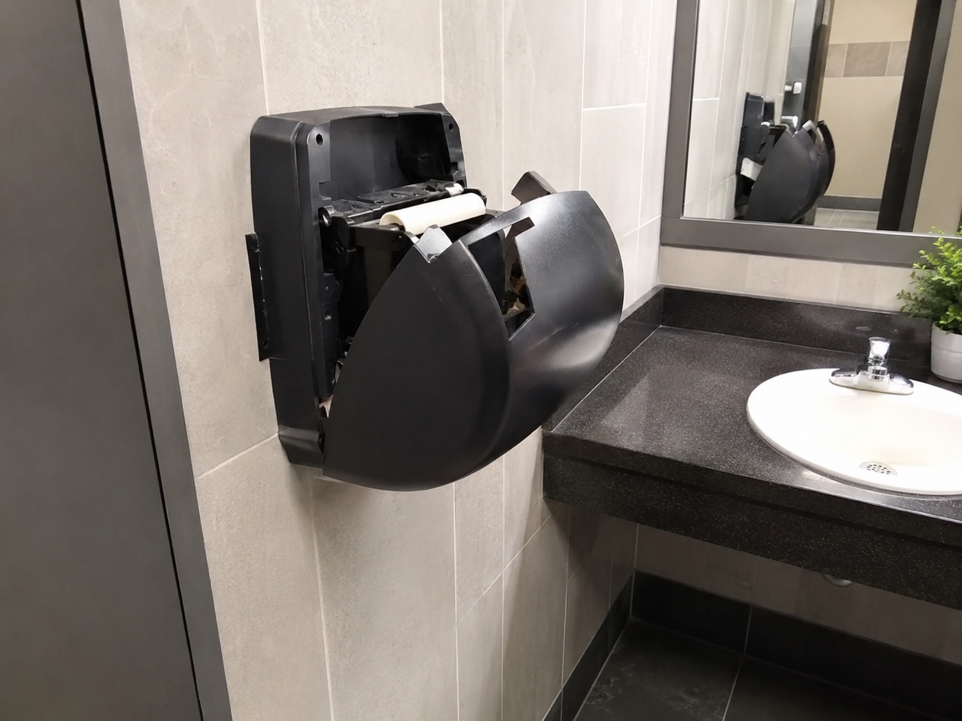 Reported - dispenser broken, hanging off the wall